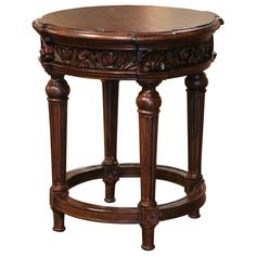 an ornate wooden table with carvings on the top and bottom, against a white background