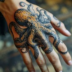 an octopus tattoo on the palm of a person's hand with intricate ink work