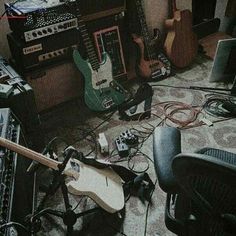 a room filled with musical instruments and amps