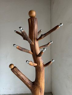 a sculpture made out of wood with balls on it's top and bottom branches