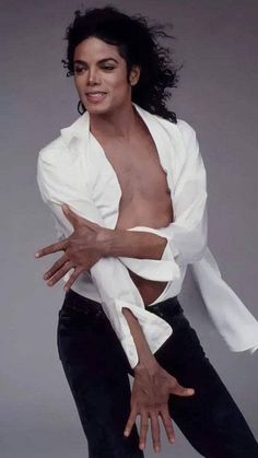 michael jackson in white shirt and black pants with his arms spread out to the side