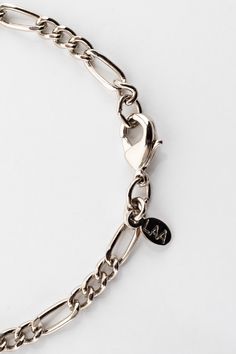 The Figaro Chain is a classic design with passionate flair due to its Italian origin. Pair this bold unisex style with the matching Figaro Bracelet JWLFB for a coordinated look. To shorten the necklace, hook the clasp directly onto one of the ovals of the chain. Please avoid contact with liquids and creams when wearing your plated jewelry. Keeping your jewelry as dry as possible will extend the life of its color and luster. | Figaro Necklace in Silver, Size 18 Snapchat Aesthetic, Figaro Bracelet, Figaro Necklace, Figaro Chains, Figaro Chain, Unisex Style, Jewelry Plate, Unisex Fashion, Fashion Bracelets