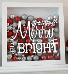 a christmas ornament in a white frame with red and silver ornaments