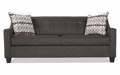 a gray couch with two pillows on it