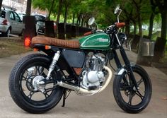 a green and black motorcycle parked on the street