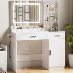 there is a vanity with a mirror and lights on the wall next to a potted plant