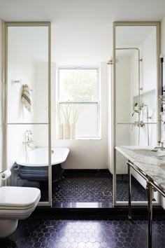 a bathroom with black and white tile flooring