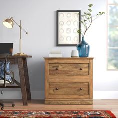 a wooden dresser sitting next to a desk with a laptop computer on top of it