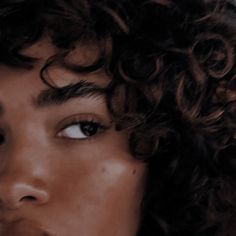 a close up of a person with curly hair