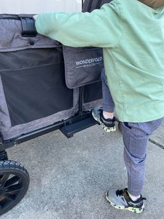 a person pushing a stroller with luggage in it