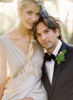 a man in a tuxedo poses with a woman