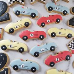 cookies decorated to look like race cars on a table