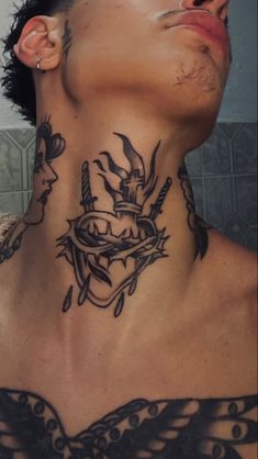 a man with tattoos on his neck and chest