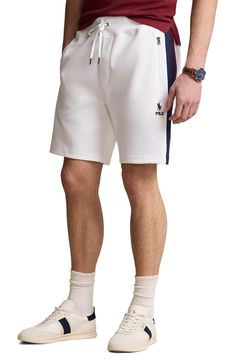 Two-tone stripes race up the legs of all-activity track shorts made of cotton-blend piqué with zippered pockets for keeping essentials securely stowed. 7 1/2" inseam; 23" leg opening; 12 1/2" front rise; 16" back rise (size Medium) Elastic/drawstring waist Side zip pockets; back patch pocket 54% cotton, 46% recycled polyester Dry clean or machine wash, dry flat Imported Athleisure Cotton Athletic Shorts With Three Stripes, White Athleisure Shorts With Three Stripes, Cotton Athletic Shorts With Three Stripes, Casual Athletic Shorts With Side Stripes, White Sports Shorts With Side Stripes, Sporty Shorts With Side Stripes, Athleisure Shorts With Side Stripes, White Athletic Shorts For Summer Jogging, Casual Cotton Shorts With Side Stripes