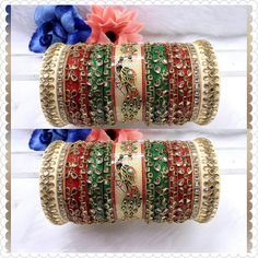 Beautiful Hand Made Traditional Indian Bangles With Kundan Work Hand Work On It. Traditional Hand Work Bangle Chura Set Is Perfect For Wedding Party Wear Or Any Indian Occasion. These Multi-Color Bangles Would Add On In Your Looks. Center Piece Of The Chuda Has Peacock Painting Which Is Making It More Attractive And Making It Real Heavy Rajwari Chuda. Available sizes - 2.4 / 2.6 / 2.8 Why is Chura worn? Popular especially among Punjabi brides-to-be, the wedding Chura signifies the beginning of their wedded life ahead. Although now the Chura has become quite a fashion statement among women, it is traditionally considered to be an important and auspicious Shringar of a newly married bride. Why do Indian brides wear red bangles after marriage? This piece of jewellery signifies good fortune an Green Bridal Sets For Diwali Ceremonial, Multicolor Kundan Traditional Wear For Puja, Red Zari Work Bangle For Diwali, Red Bangle With Zari Work For Diwali, Red Diwali Bangle With Zari Work, Ceremonial Multicolor Meenakari Lehenga, Multicolor Tilla Lehenga For Wedding, Diwali Green Bridal Sets With Cutdana, Multicolor Ceremonial Traditional Wear For Festive Season