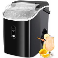 a black and white ice maker next to a glass with an orange slice on it