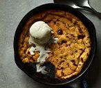 a skillet with ice cream on top of it