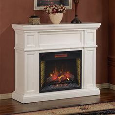 a white fireplace in a living room with red walls