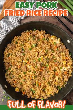 a pan filled with rice and vegetables on top of a table