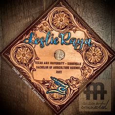 a wooden plaque with the name pelle raya on it in blue and brown