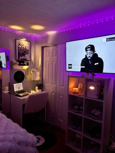 a bedroom with purple lighting and a flat screen tv