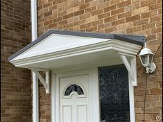 a white front door on a brick building