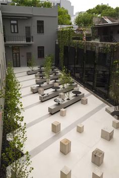 an outdoor courtyard with benches and trees