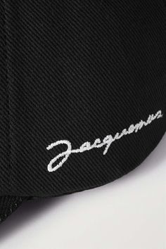 JACQUEMUS La Casquette embroidered cotton-twill baseball cap | NET-A-PORTER Black Curved Brim Baseball Cap With Embroidered Logo, Classic Cotton Snapback Hat With Embroidered Logo, Black Cotton Hat With Curved Visor, Classic Embroidered Snapback Flat Cap, Classic Snapback Flat Cap With Embroidered Logo, Classic Black Snapback Hat With Embroidered Logo, Classic Cotton Fitted Hat With Embroidered Logo, Classic Black Fitted Hat With Embroidered Logo, Classic Cotton Baseball Cap With Logo Detail