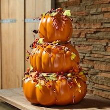 three pumpkins are stacked on top of each other