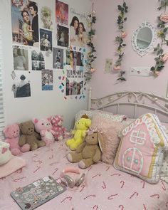 there are many stuffed animals on the bed in this girls'room, including teddy bears