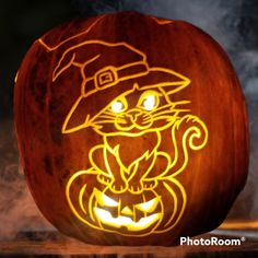 a carved pumpkin with an image of a cat in a hat on it's face