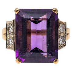 14k yellow gold ring. This gorgeous ring has a large emerald cut faceted, dark purple color amethyst center, approximately 9.25 CTS, prong set and flanked by two large single cut diamonds, approximately 0.12 TCW, and finished by split style shoulders. Marks: 14k Dimensions: 9/16" long x 5/8" across the top Weight: 4.0 gross dwt Ring Size: 5.5 Dark Purple Color, Amethyst And Diamond Ring, Yellow Gold Ring, Purple Amethyst, Yellow Gold Rings, Dark Purple, Emerald Cut, Purple Color, Prong Setting