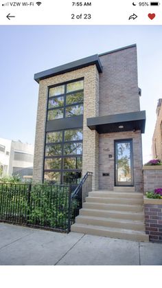 a brick house with stairs leading up to the front door