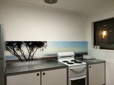 a white stove top oven sitting inside of a kitchen