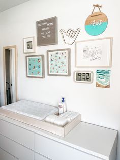 a baby crib with lots of pictures on the wall