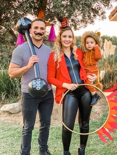 a man and woman in costumes holding a child