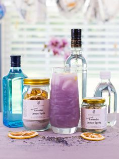 bottles and jars filled with liquid sitting on top of a table