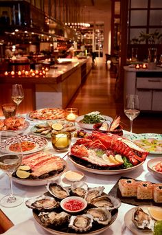 a table full of seafood and wine glasses