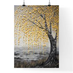 a tree with yellow leaves hanging from it's branches in front of a gray sky