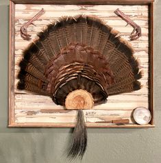 a wooden frame with a turkey's head hanging on the wall