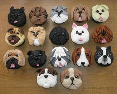 there are many different dogs made out of cupcakes on the table, one is brown and white