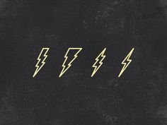 four yellow lightning bolt stickers on a black surface with white and gold lines in the middle