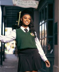 a woman in a school uniform is posing for the camera