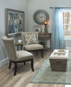 a living room filled with furniture and a clock on the wall above it's windows