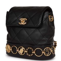 This Small Charm Backpack is of Black Calfskin with aged gold hardware, features metal details depicting Chanel icons and symbols, classic CC turnlock closure, an exterior back pocket, and aged gold tone interwoven chainlink shoulder straps.The interior is lined in black fabric and features a singular leather pocket on the back wall. Collection: 23BOrigin: ItalyCondition: New and never worn Accompanied by: Chanel box, Chanel dustbag, detachable shoulder strap, retail UPC and ribbonMeasurements: