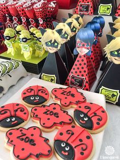 decorated cookies are on display in front of other items at a birthday party for children