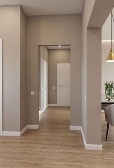 an empty room with hard wood flooring and white trim on the walls is shown