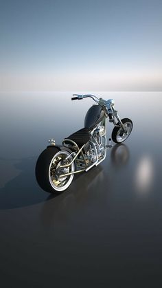 a black and silver motorcycle on a reflective surface with blue sky in the back ground