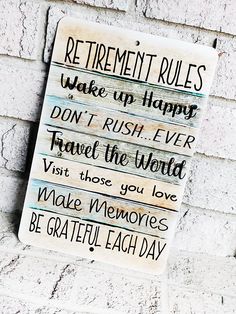 a sign on the side of a building that says retirement rules wake up happy don't rush i ver travel the world visit those you love make memories be grateful each day