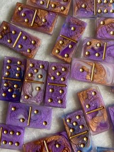 purple and gold dices are laying on the ground